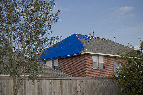 house with roof that is badly damaged