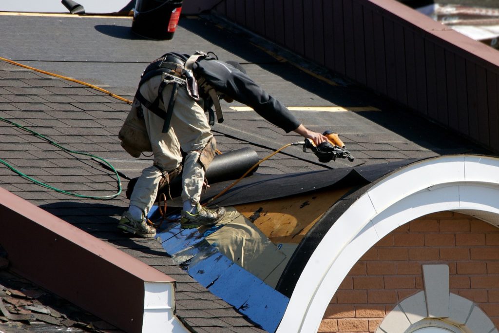 Man fixing roof leak