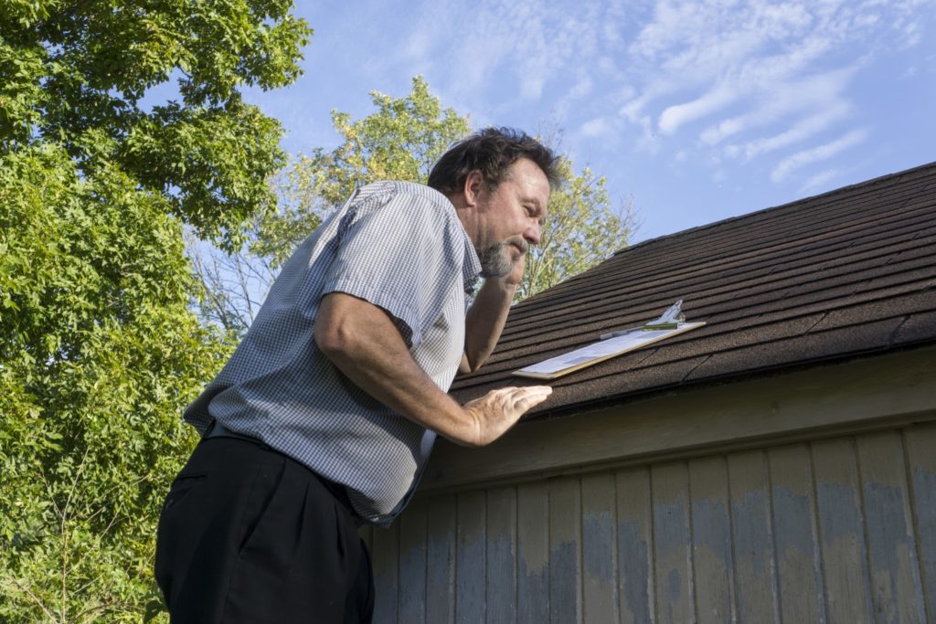 Man checking roof